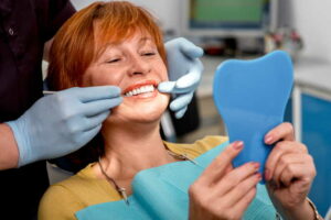 Denture Implants - Woman in dental chair
